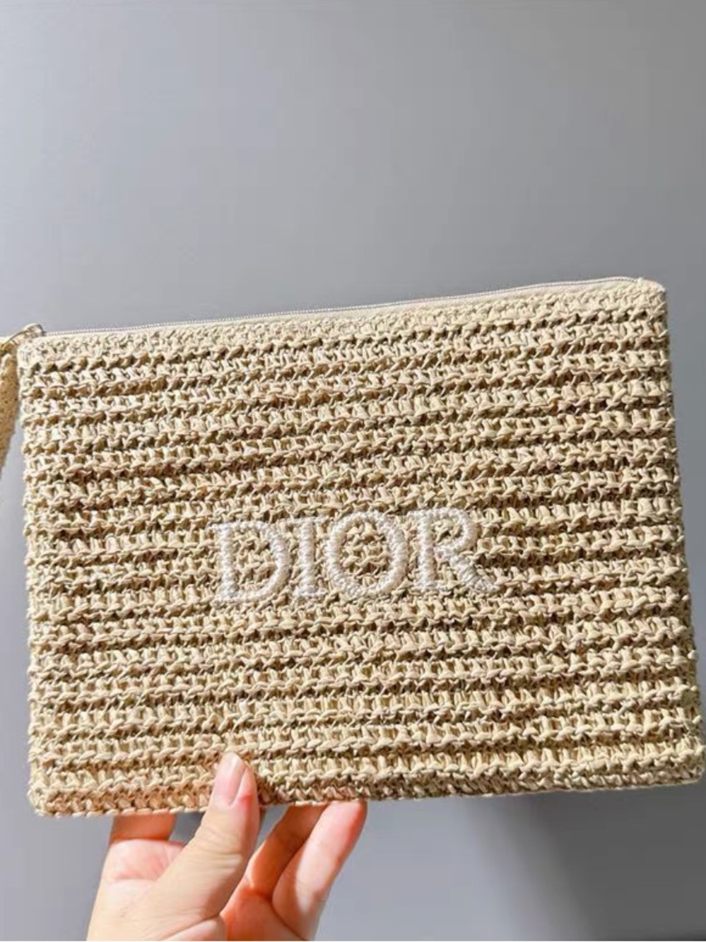 Dior straw makeup pouch